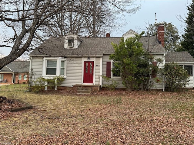 cape cod-style house with roof with shingles and a chimney