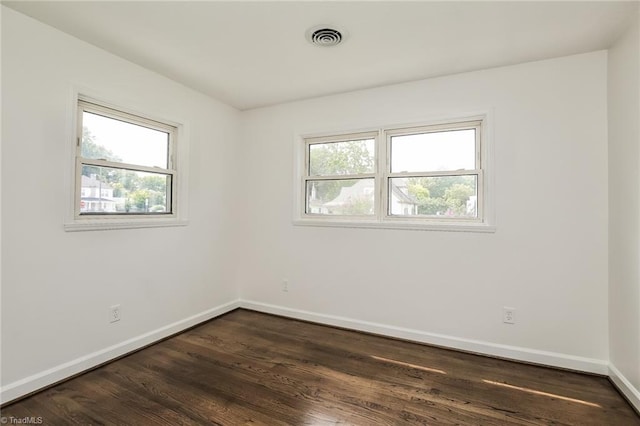 empty room featuring dark wood-type flooring