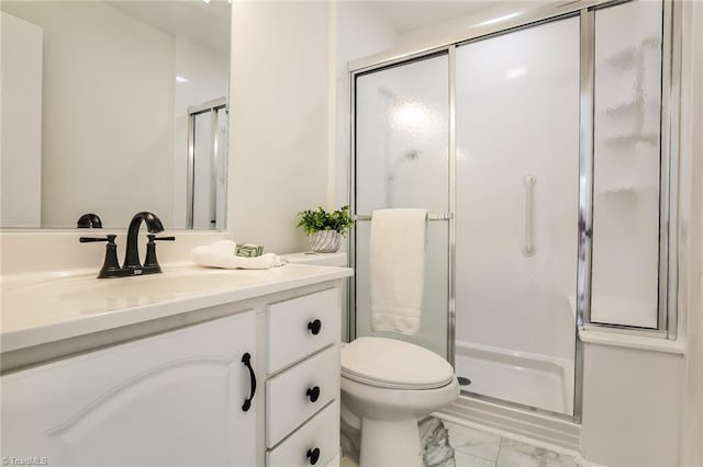 bathroom featuring vanity, toilet, and an enclosed shower