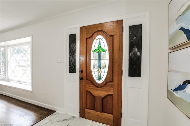 foyer featuring crown molding