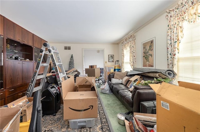 living room featuring ornamental molding and visible vents