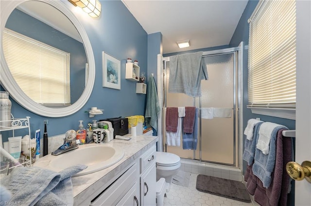 full bath with toilet, tile patterned flooring, vanity, and a shower stall