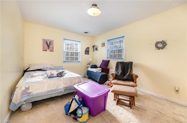 bedroom featuring carpet and baseboards