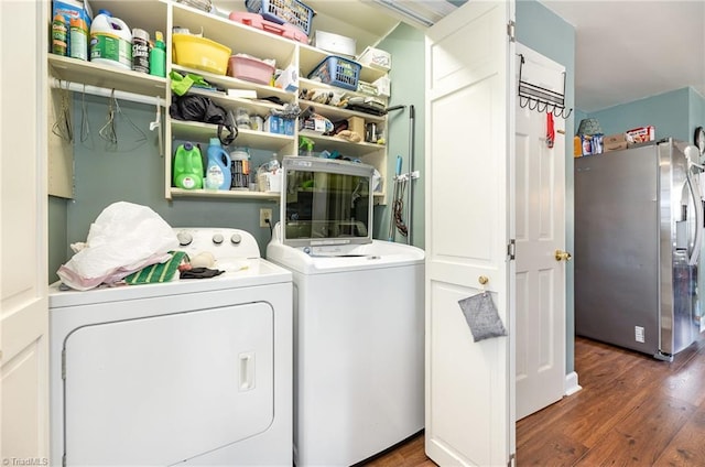 laundry room with laundry area, independent washer and dryer, and wood finished floors