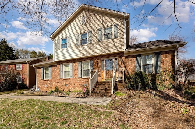 view of front of property with crawl space, a front lawn, and brick siding