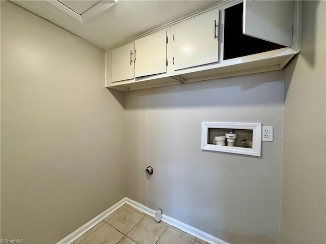 laundry area featuring light tile patterned floors, baseboards, cabinet space, and hookup for a washing machine