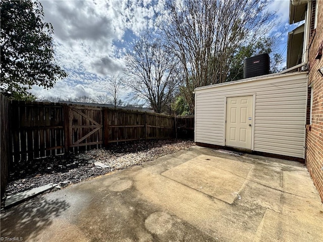 exterior space with central AC unit and fence private yard