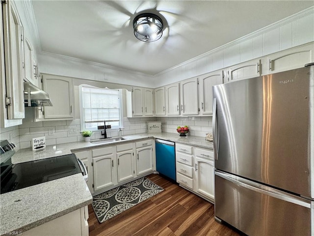 kitchen featuring a sink, appliances with stainless steel finishes, decorative backsplash, extractor fan, and dark wood-style flooring