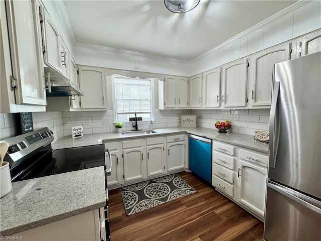 kitchen with a sink, under cabinet range hood, ornamental molding, appliances with stainless steel finishes, and dark wood-style flooring