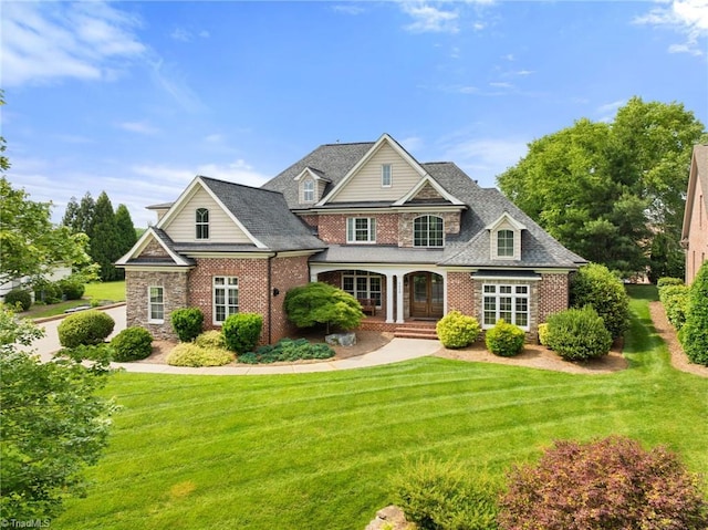 5459 Brookberry Farm Rd, Winston-Salem, NC 27106 - view of front of house with brick siding, a front yard, and a porch