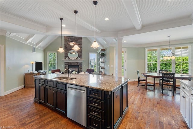 5459 Brookberry Farm Rd, Winston-Salem, NC 27106 - kitchen featuring stainless steel dishwasher, a fireplace, open floor plan, a sink, and baseboards