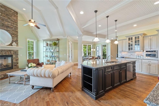 5459 Brookberry Farm Rd, Winston-Salem, NC 27106 - kitchen with a sink, stainless steel appliances, open floor plan, a stone fireplace, and a center island with sink
