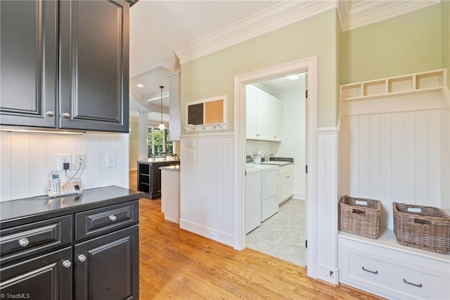 5459 Brookberry Farm Rd, Winston-Salem, NC 27106 - hall featuring ornamental molding, separate washer and dryer, light wood finished floors, a wainscoted wall, and a sink