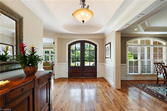 5459 Brookberry Farm Rd, Winston-Salem, NC 27106 - foyer entrance featuring crown molding, french doors, a raised ceiling, a wainscoted wall, and a decorative wall