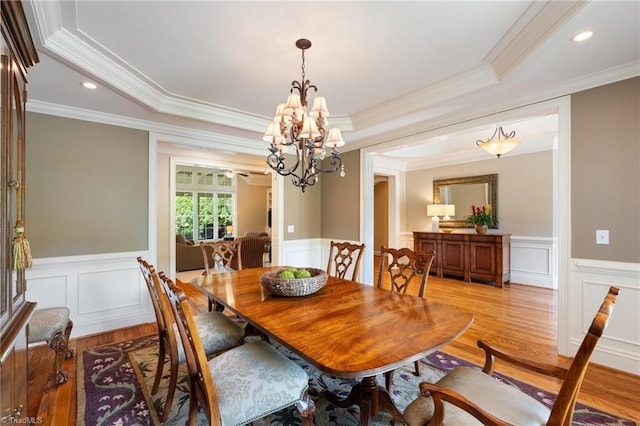 5459 Brookberry Farm Rd, Winston-Salem, NC 27106 - dining room with light wood-style flooring, crown molding, a chandelier, a raised ceiling, and wainscoting