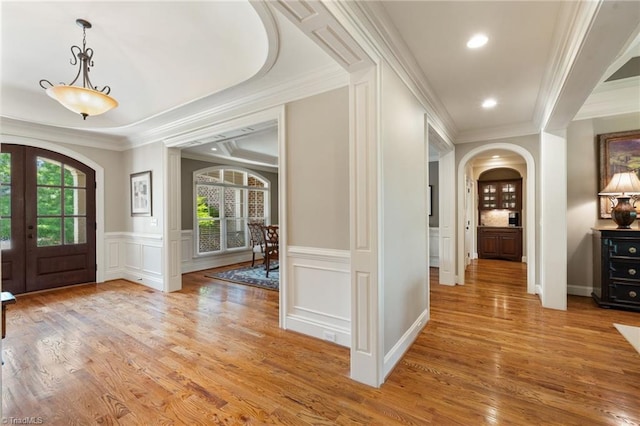 5459 Brookberry Farm Rd, Winston-Salem, NC 27106 - entryway with arched walkways, a decorative wall, light wood-type flooring, crown molding, and french doors
