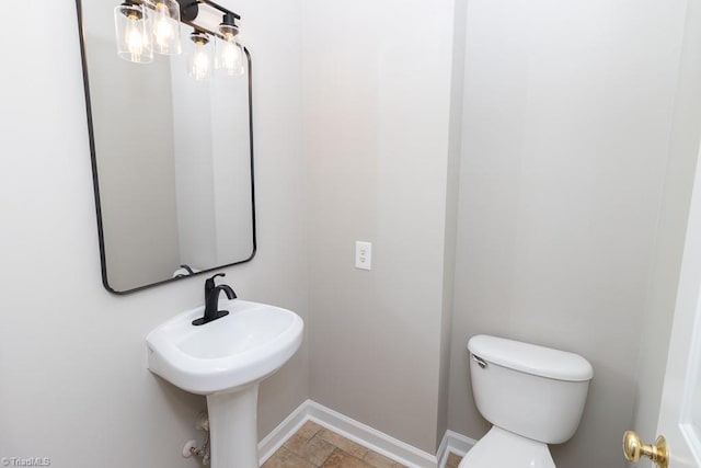 7905 Cress Ct, Oak Ridge, NC 27310 - half bathroom with toilet, baseboards, and stone finish flooring
