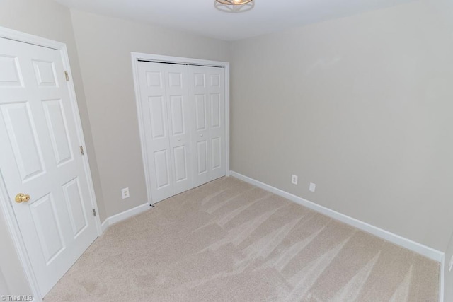 7905 Cress Ct, Oak Ridge, NC 27310 - unfurnished bedroom featuring light colored carpet, a closet, and baseboards