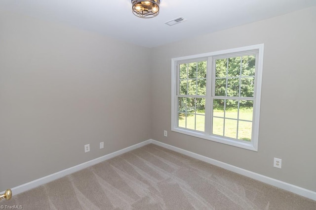 7905 Cress Ct, Oak Ridge, NC 27310 - unfurnished room featuring baseboards, plenty of natural light, and light carpet