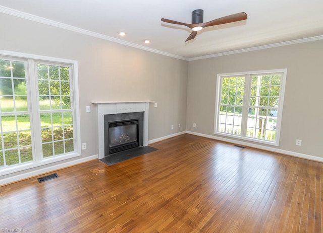 7905 Cress Ct, Oak Ridge, NC 27310 - unfurnished living room featuring a ceiling fan, a fireplace with flush hearth, hardwood / wood-style floors, crown molding, and baseboards
