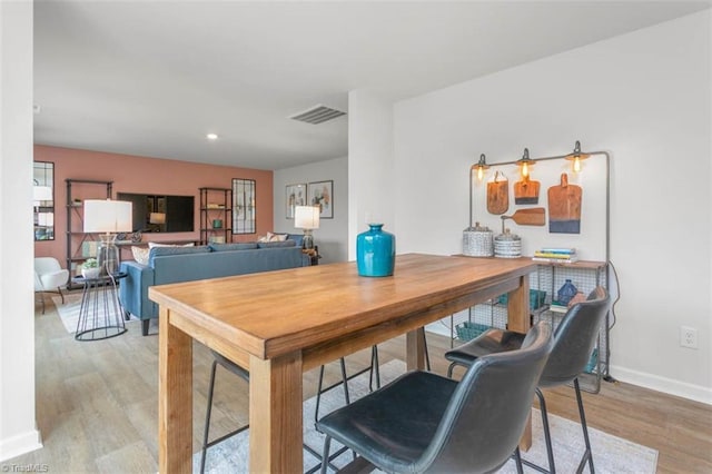 dining space with light wood-type flooring