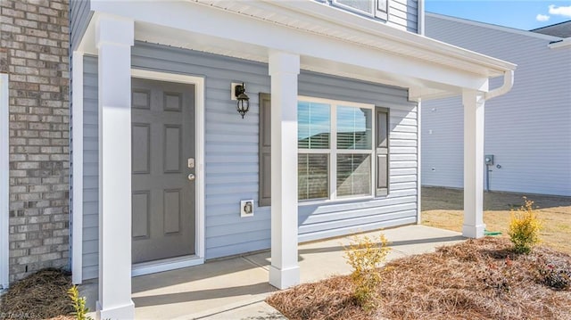 view of exterior entry with a porch