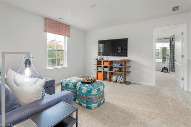 living room featuring a wealth of natural light and carpet floors