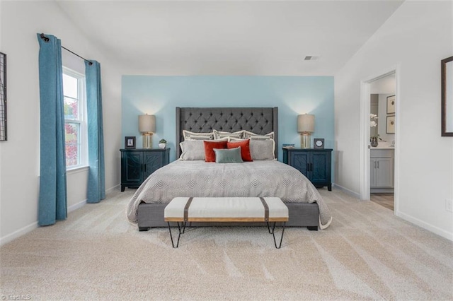 carpeted bedroom featuring ensuite bathroom