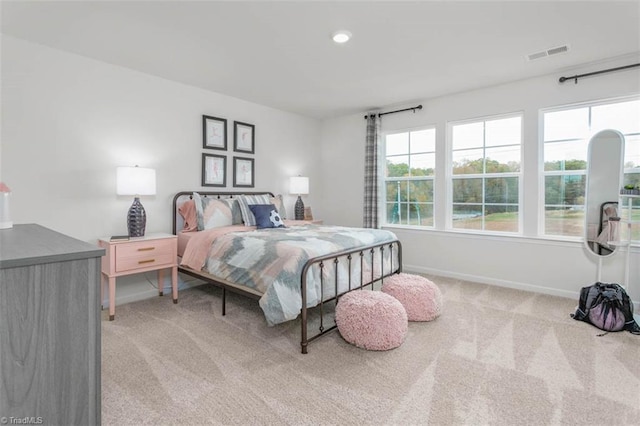 carpeted bedroom featuring multiple windows