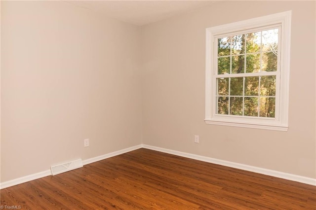 unfurnished room featuring dark wood-type flooring