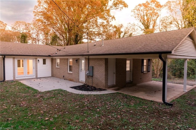 back house at dusk with a patio