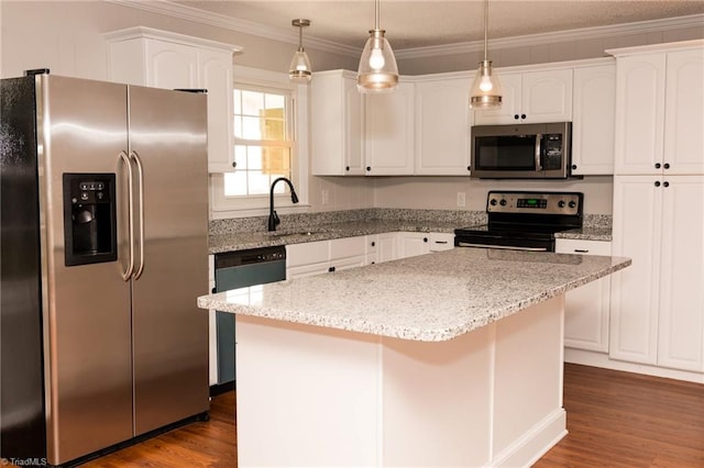 kitchen featuring light stone countertops, a center island, hanging light fixtures, stainless steel appliances, and white cabinets