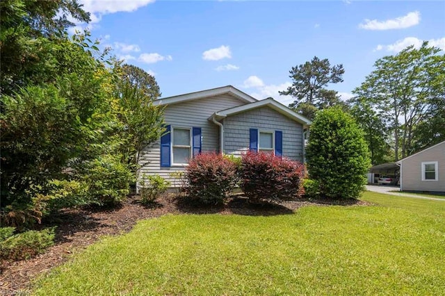 207 Bingham St, Carthage, NC 28327 - view of side of property with a carport and a yard