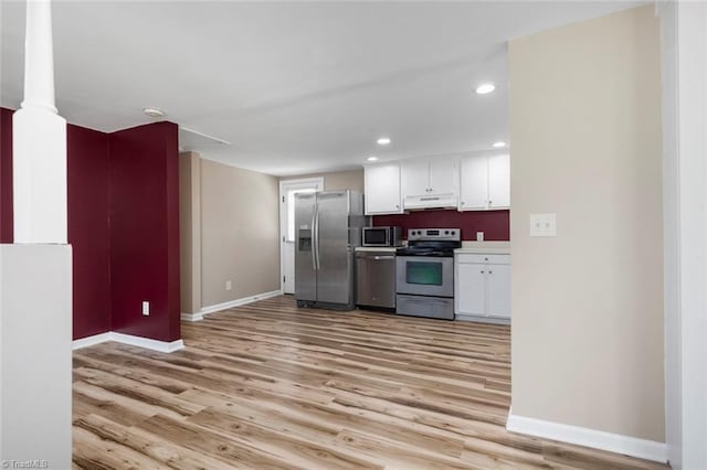 207 Bingham St, Carthage, NC 28327 - kitchen with appliances with stainless steel finishes, under cabinet range hood, baseboards, white cabinets, and recessed lighting