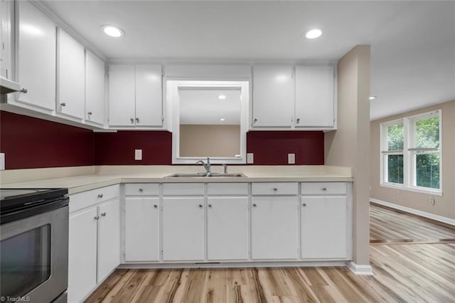 207 Bingham St, Carthage, NC 28327 - kitchen featuring a sink, stainless steel range with electric stovetop, white cabinetry, light wood-type flooring, and recessed lighting