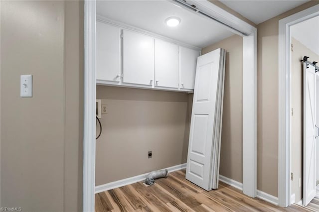 207 Bingham St, Carthage, NC 28327 - laundry area featuring cabinet space, light wood finished floors, baseboards, and electric dryer hookup