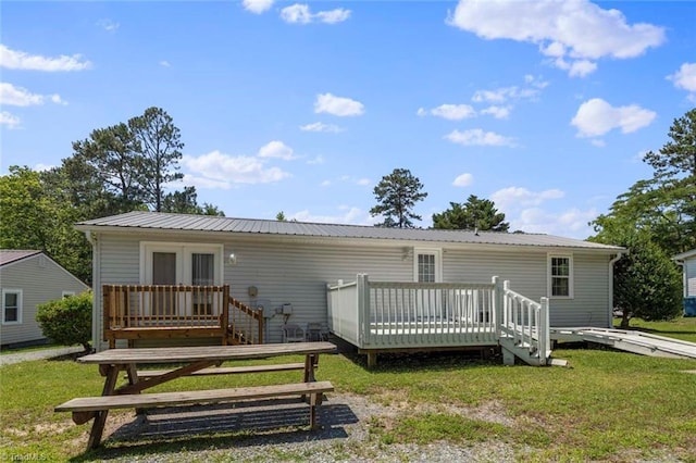 207 Bingham St, Carthage, NC 28327 - rear view of property with a wooden deck, a yard, and metal roof