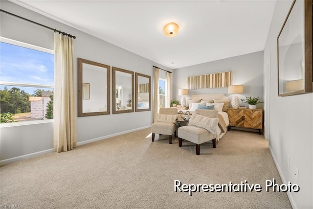 bedroom featuring light colored carpet and baseboards