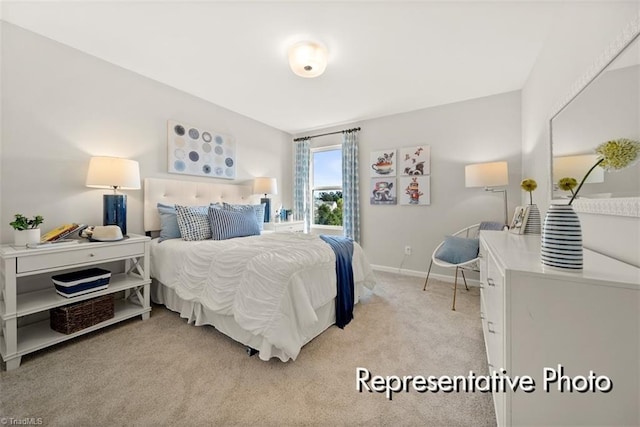 bedroom featuring light carpet and baseboards