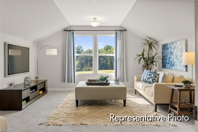 living area featuring light colored carpet, vaulted ceiling, and baseboards