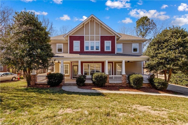 view of front of house with a porch and a front yard