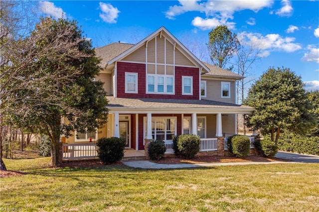 craftsman-style house featuring a porch and a front yard