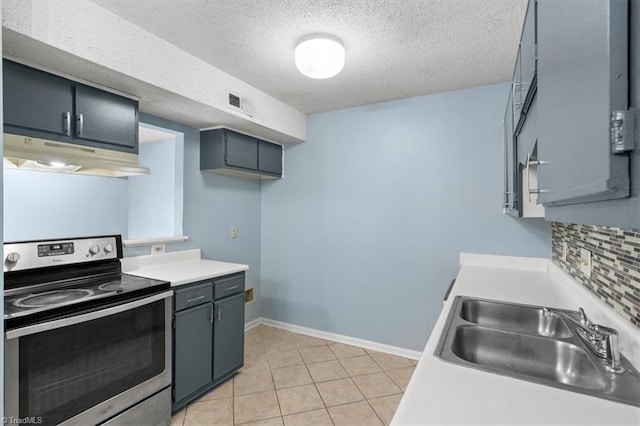 kitchen with light tile patterned floors, stainless steel range with electric stovetop, a textured ceiling, and sink