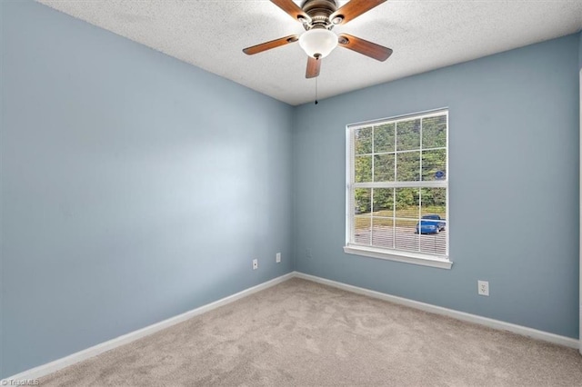 carpeted empty room featuring a textured ceiling and ceiling fan