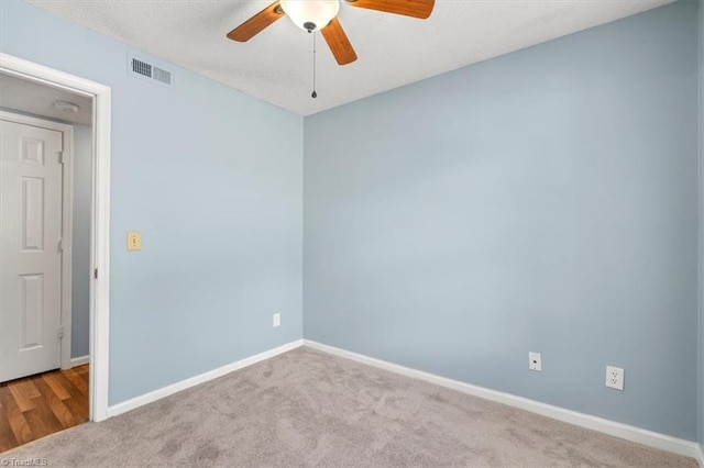 carpeted empty room with ceiling fan