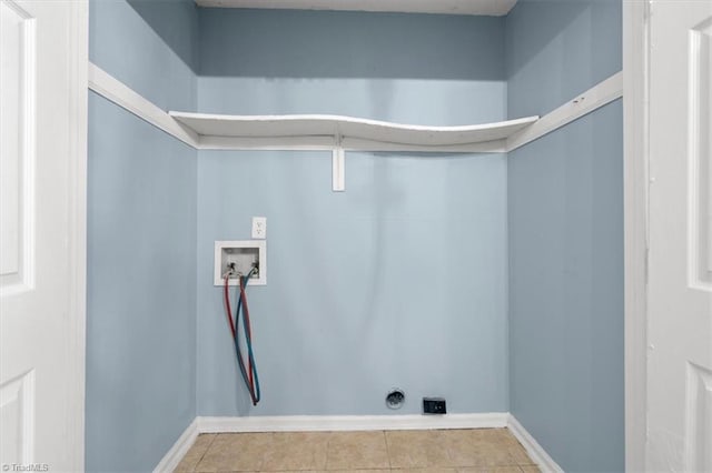 washroom featuring hookup for a washing machine and light tile patterned floors