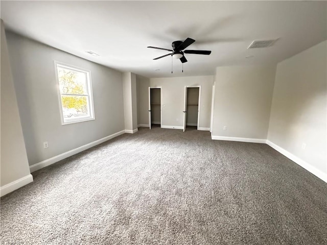 unfurnished bedroom with ceiling fan and dark carpet