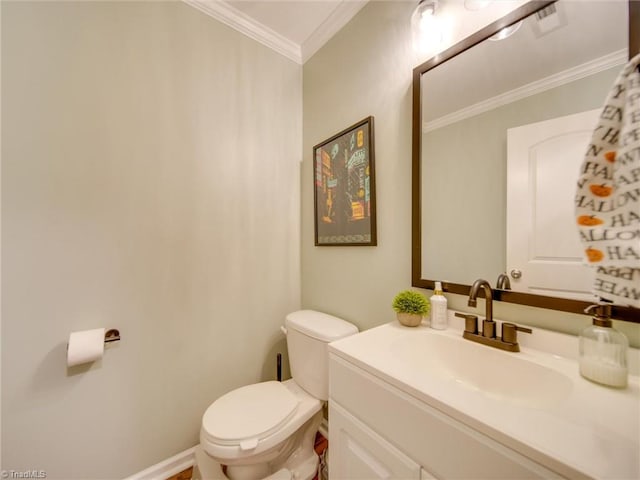 bathroom with crown molding, vanity, and toilet