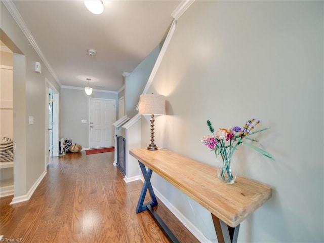 corridor featuring hardwood / wood-style flooring and crown molding