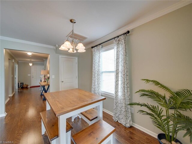 dining space featuring ornamental molding, dark hardwood / wood-style floors, and an inviting chandelier